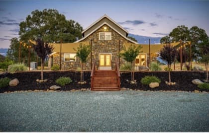 The Stone Barn at Cosumnes River Ranch set for a wedding at golden hour